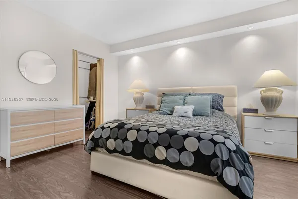 a bedroom with a bed and a night stand