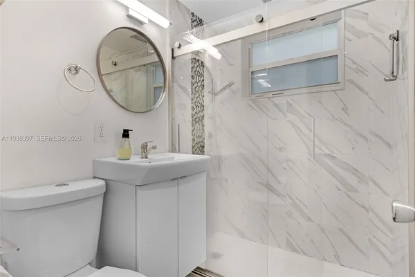 a view of a house with a big yard and palm trees