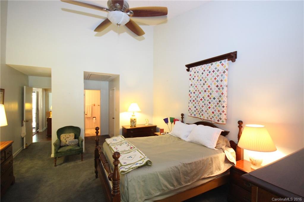 33 Old Post Road, Unit 33 Lake Wylie, SC 29710 - Photo 8 of 15 a bedroom with a bed and a chandelier