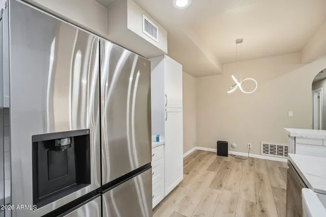a view of a kitchen with a sink and refrigerator