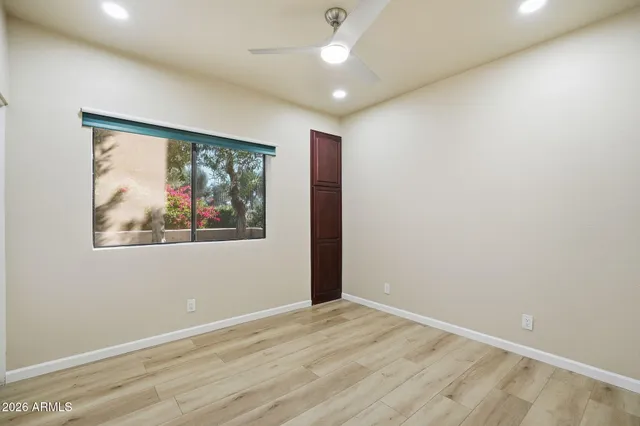 en empty room with window and ceiling fan