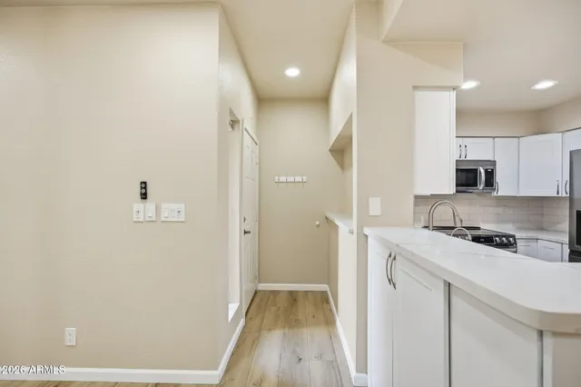 a kitchen with a sink a refrigerator and cabinets