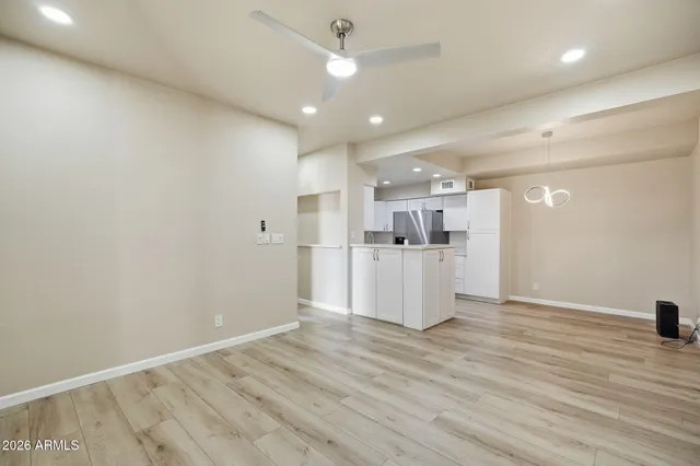 a view of a kitchen with a sink and wooden floor