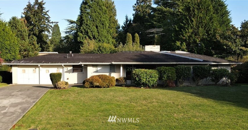 a backyard of a house with yard and outdoor seating