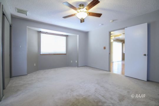 636 Heather Court Ridgecrest, CA 93555 - Photo 21 of 33 an empty room with a window and a fan