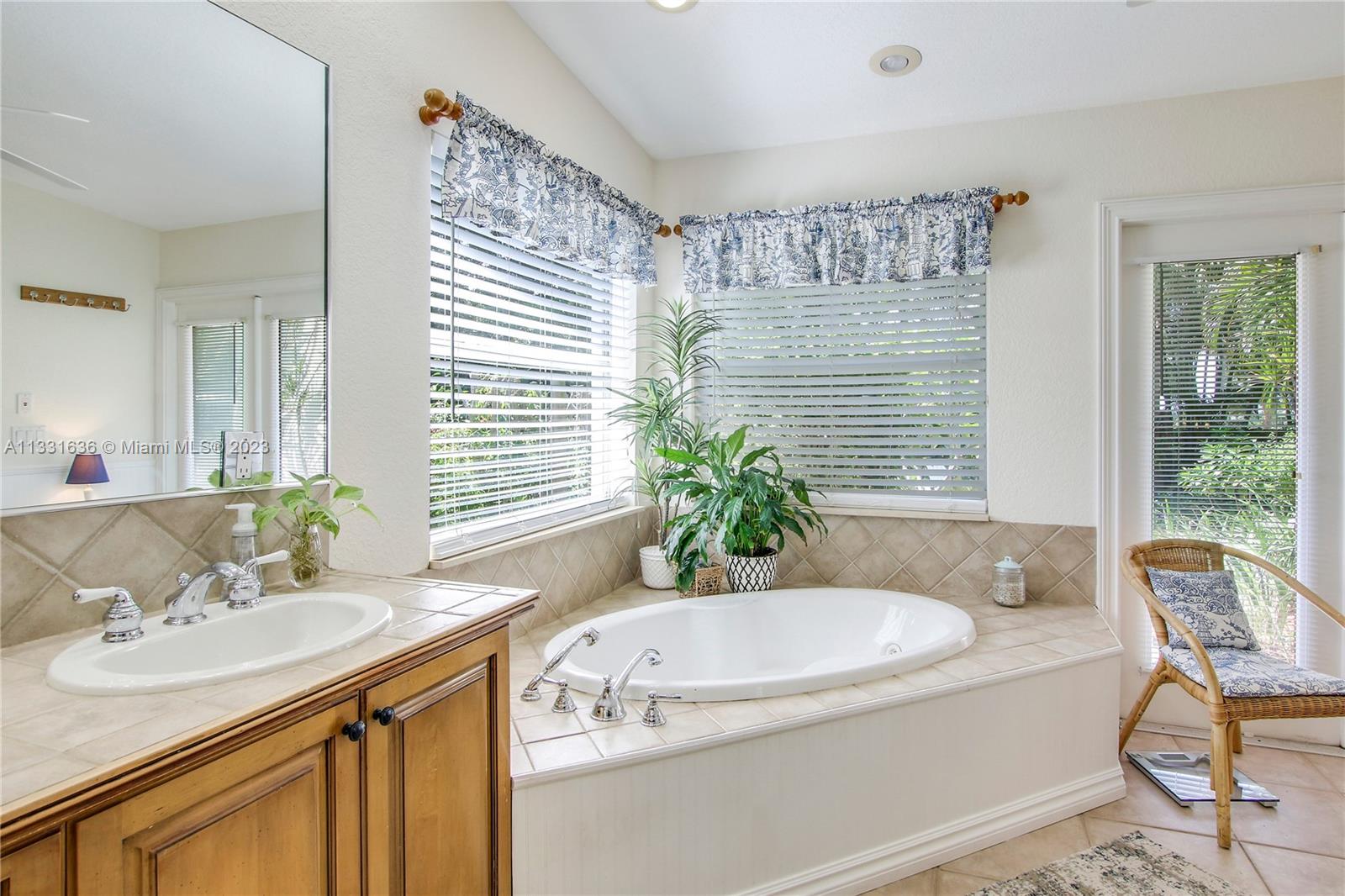 361 Zenith Lane Juno Beach, FL 33408 - Photo 12 of 36 a bathroom with a granite countertop sink and a bathtub
