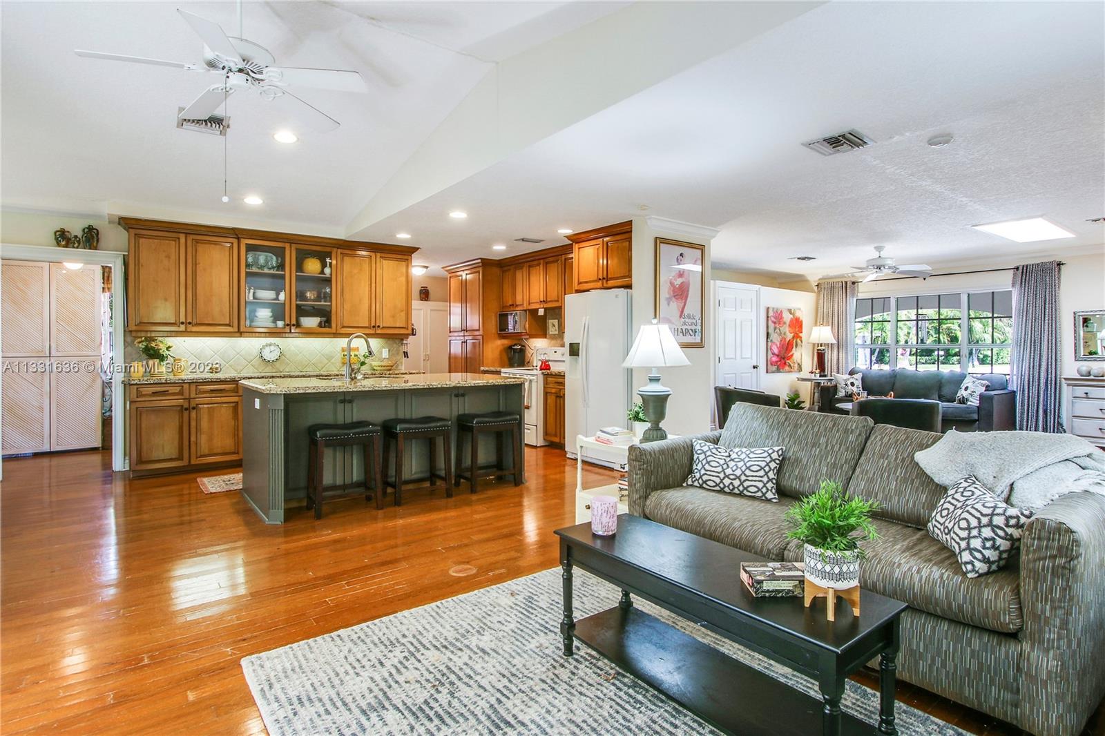 361 Zenith Lane Juno Beach, FL 33408 - Photo 16 of 36 a living room with stainless steel appliances furniture and a kitchen view