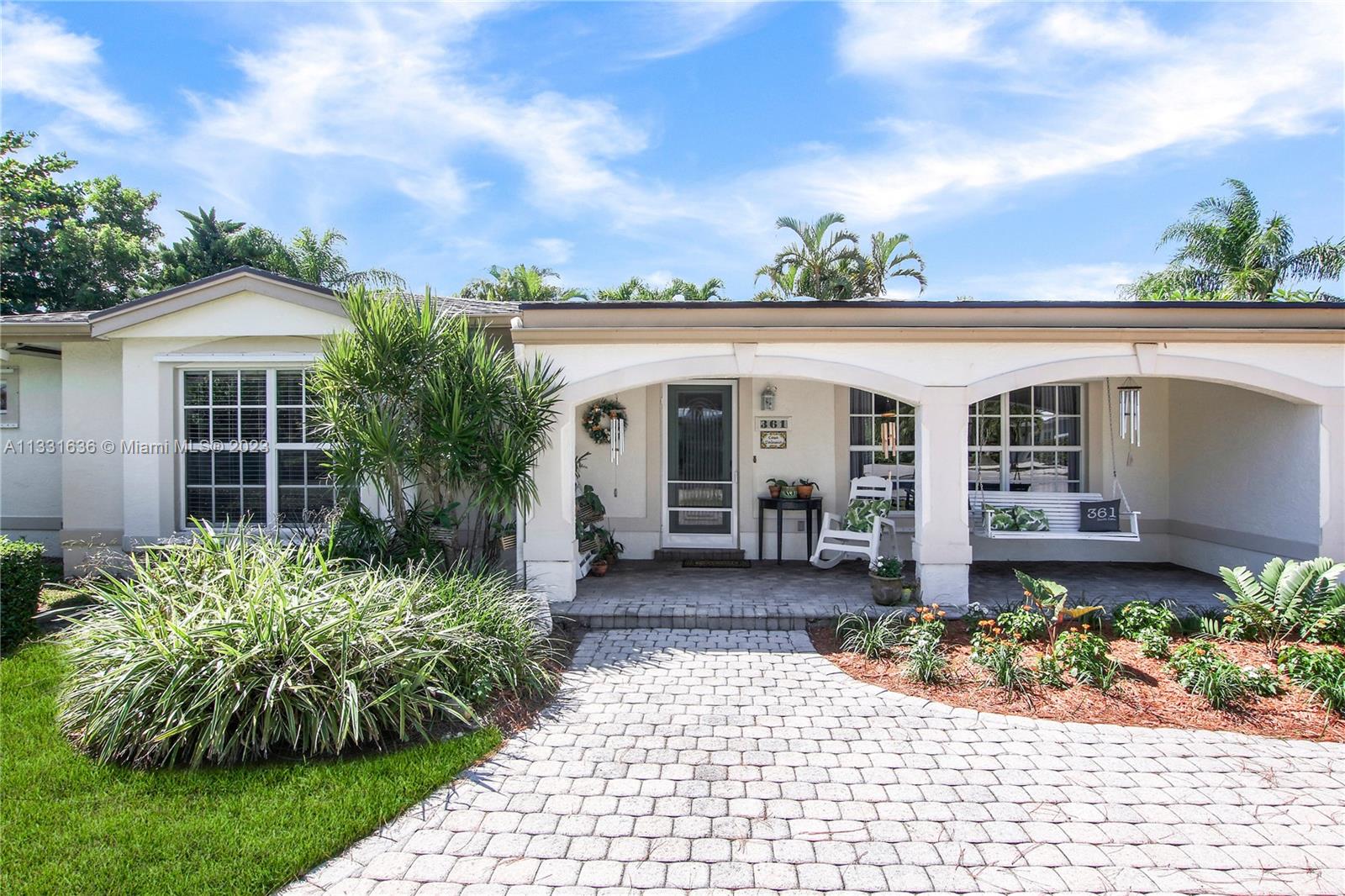 361 Zenith Lane Juno Beach, FL 33408 - Photo 2 of 36 a front view of a house with garden