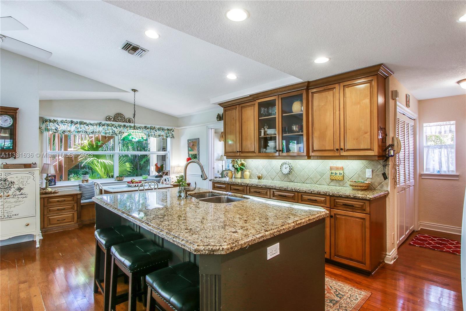 361 Zenith Lane Juno Beach, FL 33408 - Photo 23 of 36 a kitchen with a stove a sink a counter space and wooden floor