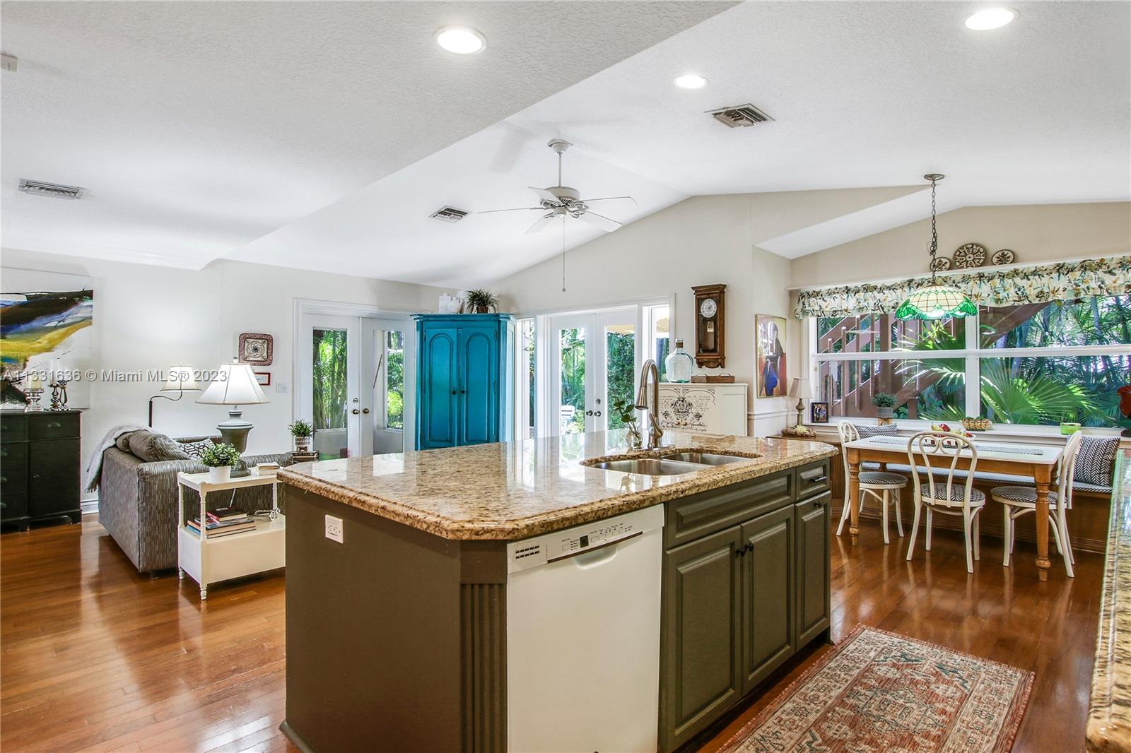 361 Zenith Lane Juno Beach, FL 33408 - Photo 24 of 36 a kitchen with stainless steel appliances granite countertop a stove and a wooden floors