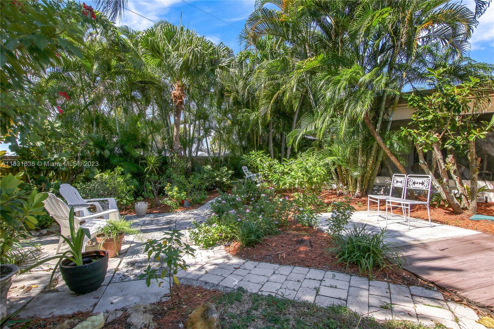 361 Zenith Lane Juno Beach, FL 33408 - Photo 29 of 36 a view of yard with green space and seating