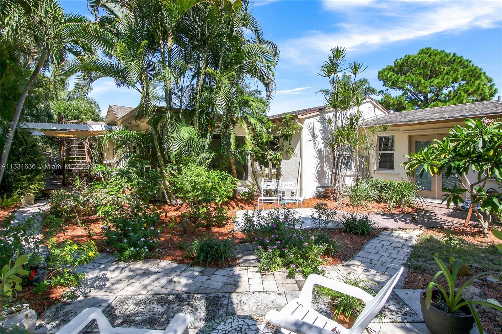 361 Zenith Lane Juno Beach, FL 33408 - Photo 30 of 36 a view of a house with a yard and garden