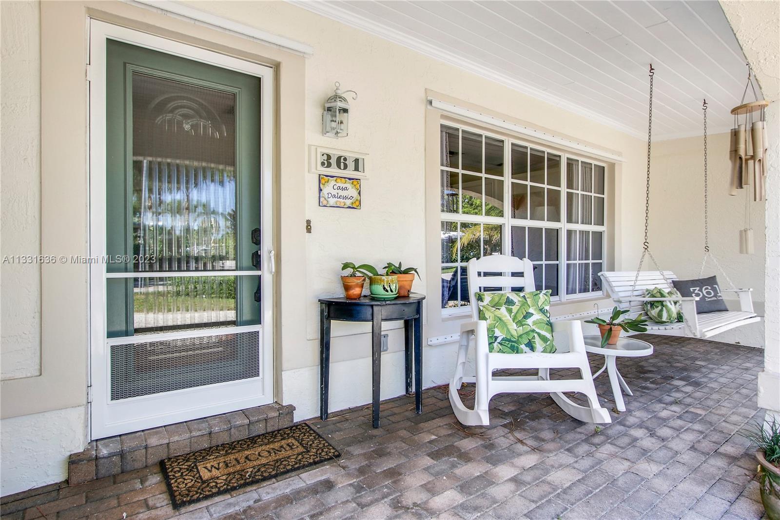361 Zenith Lane Juno Beach, FL 33408 - Photo 3 of 36 a view of porch with a bench and a potted plant