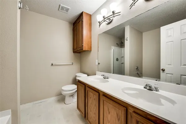 a bathroom with a white bath tub and shower