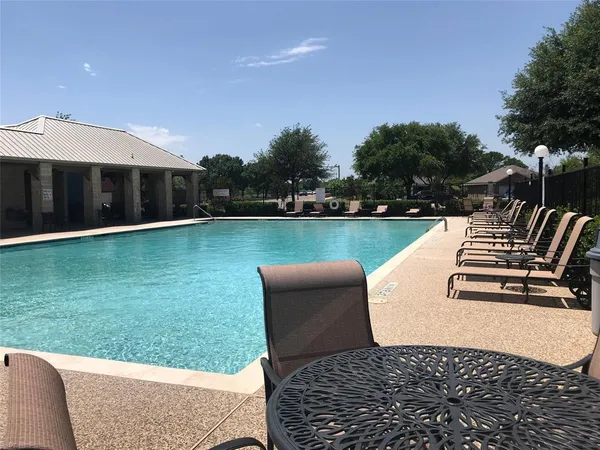 a view of a swimming pool with a yard