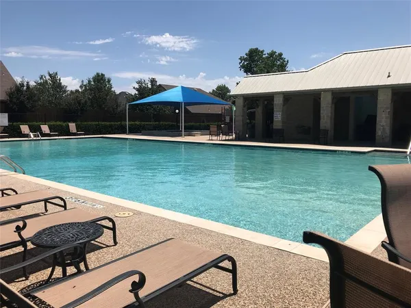 swimming pool view with a outdoor seating space