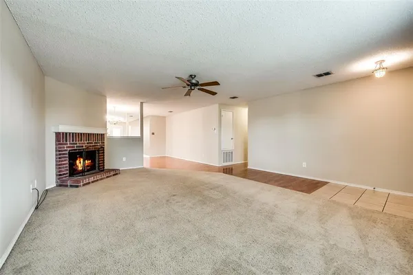 a view of an empty room with a fireplace