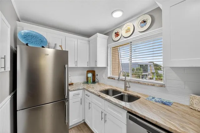 a kitchen with stainless steel appliances and a refrigerator