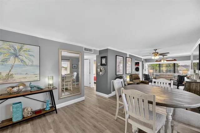 a dining room with furniture and wooden floor