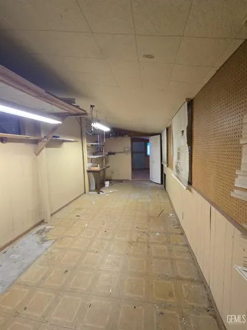 a view of a yard with plants and a bench