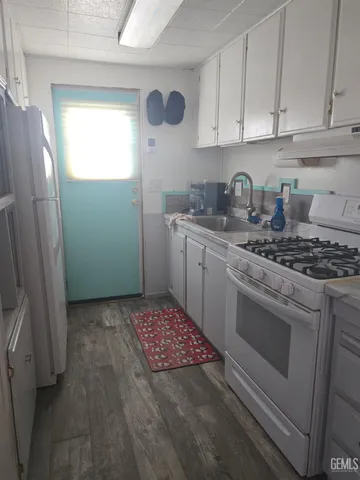 a kitchen with stainless steel appliances granite countertop a sink stove and cabinets