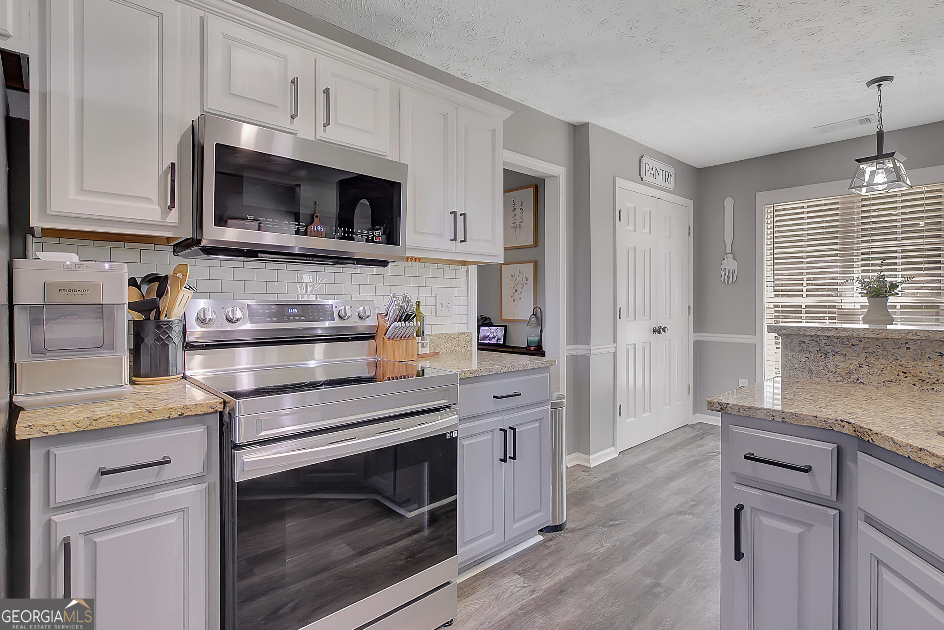 229 John Lovelace Road LaGrange, GA 30241 - Photo 29 of 59 a kitchen with stainless steel appliances white cabinets and a stove top oven