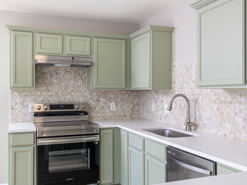 3628 Windhill Loop Round Rock, TX 78681 - Photo 11 of 24 a kitchen with a sink stove and cabinets