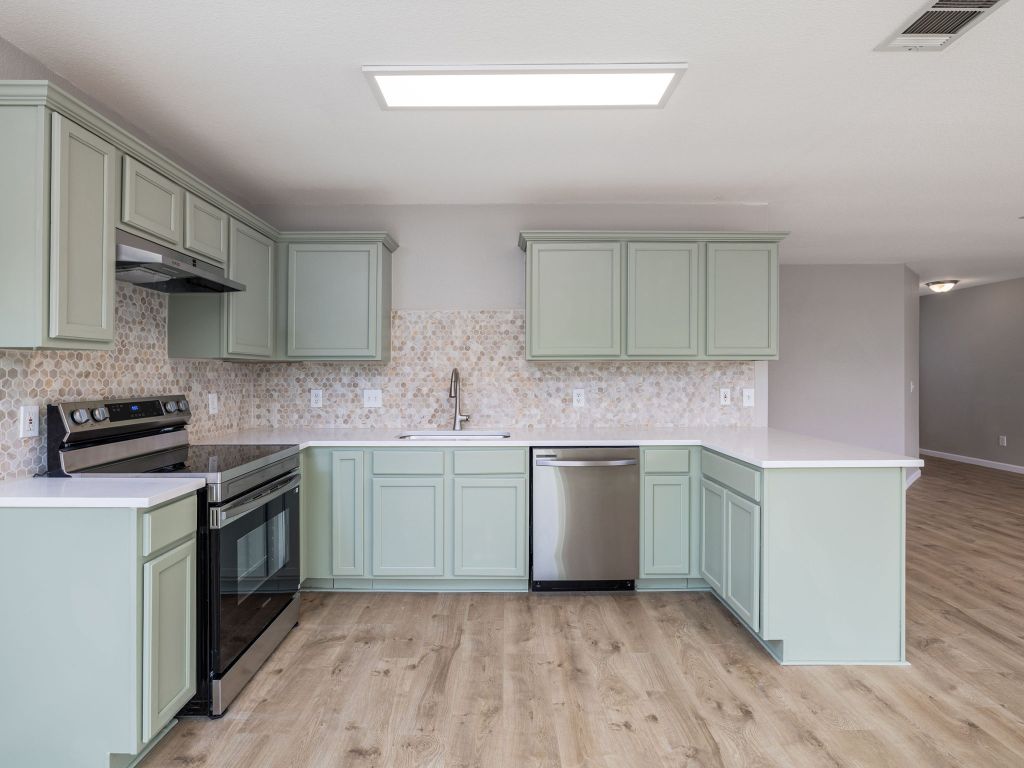 3628 Windhill Loop Round Rock, TX 78681 - Photo 12 of 24 a kitchen with stainless steel appliances granite countertop a sink and stove top oven