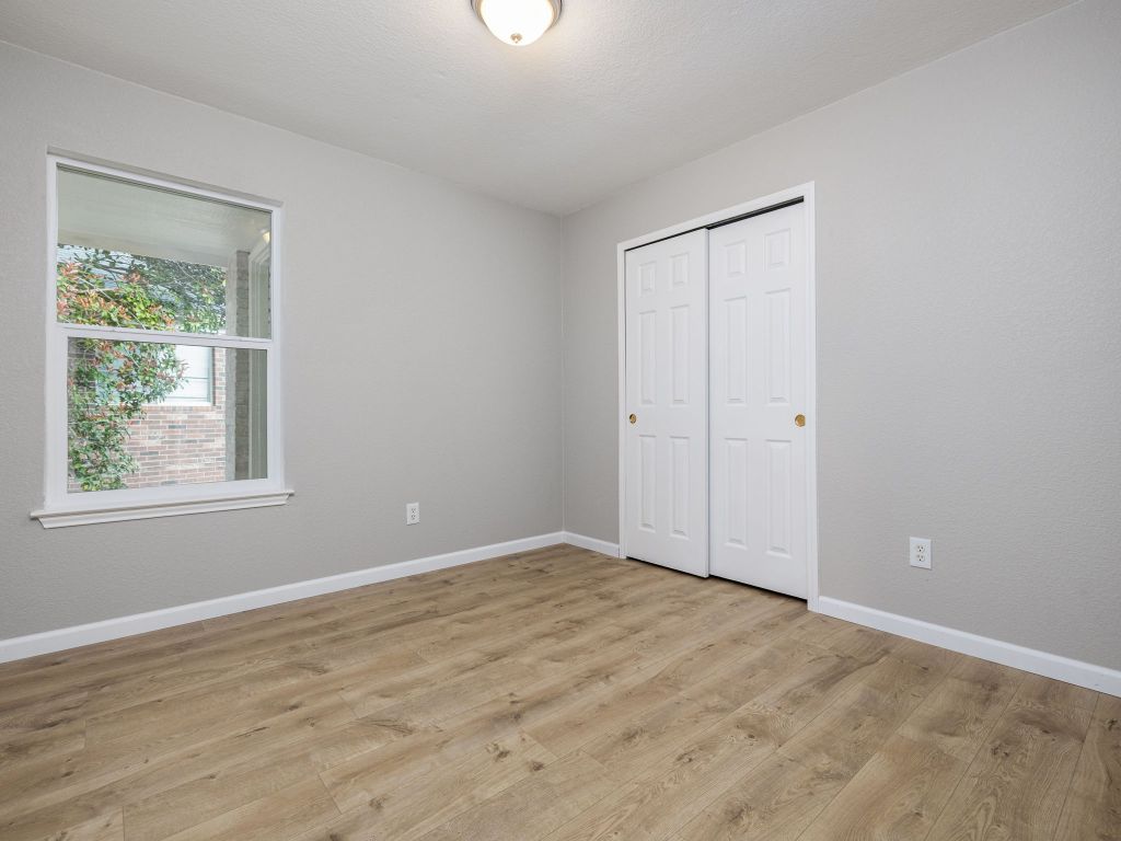 3628 Windhill Loop Round Rock, TX 78681 - Photo 18 of 24 a view of an empty room with wooden floor and a window