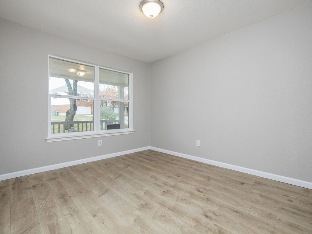 3628 Windhill Loop Round Rock, TX 78681 - Photo 20 of 24 an empty room with wooden floor and windows