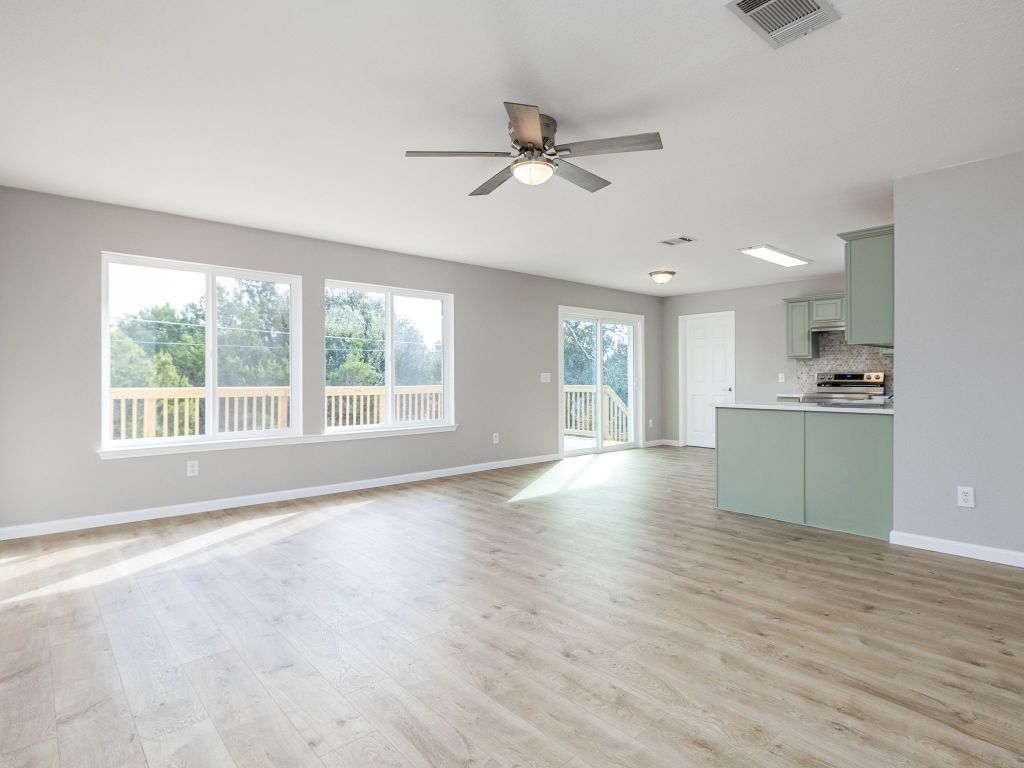 3628 Windhill Loop Round Rock, TX 78681 - Photo 7 of 24 a view of an empty room with window and wooden floor