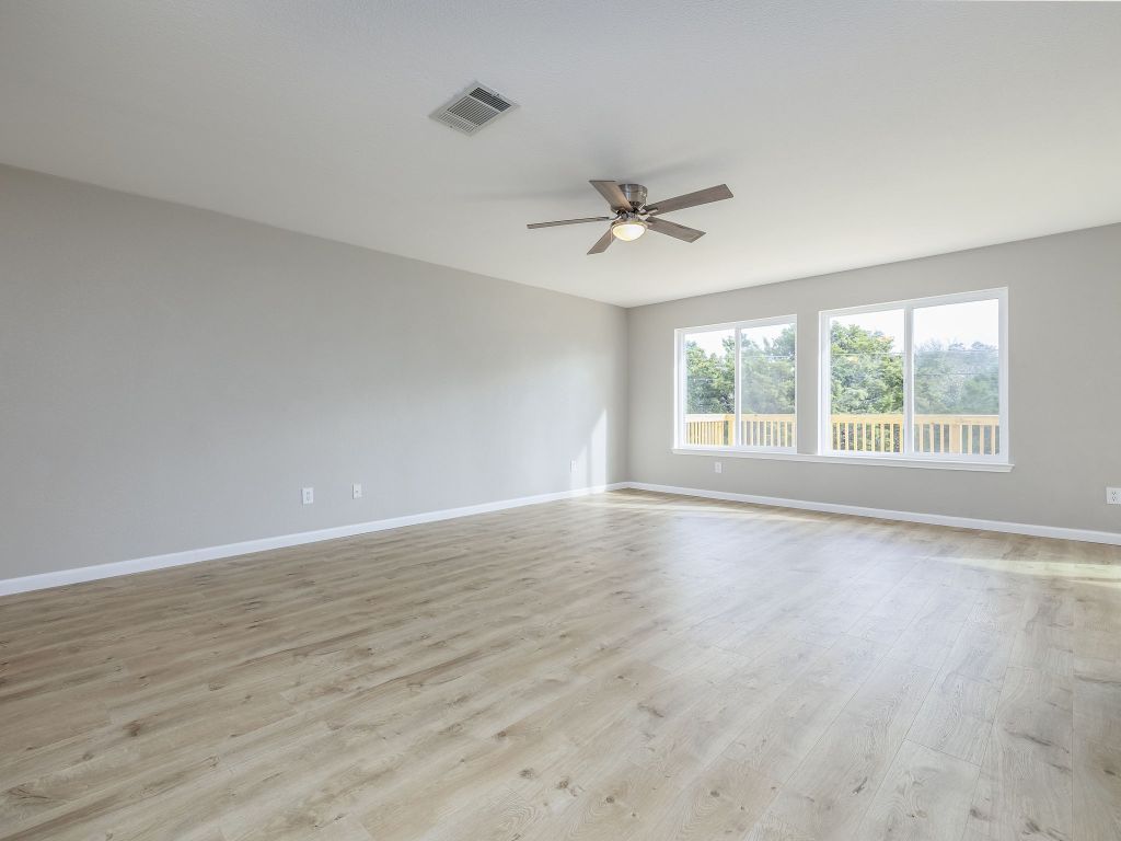 3628 Windhill Loop Round Rock, TX 78681 - Photo 8 of 24 a view of an empty room with a window and wooden floor
