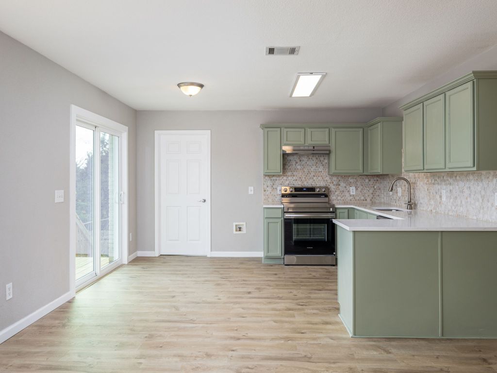 3628 Windhill Loop Round Rock, TX 78681 - Photo 9 of 24 a kitchen with granite countertop a stove and a sink
