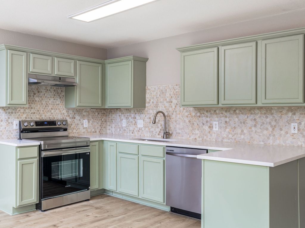 3628 Windhill Loop Round Rock, TX 78681 - Photo 10 of 24 a kitchen with stainless steel appliances granite countertop a stove and a sink