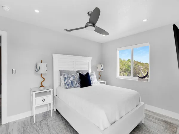 a bedroom with a large bed and a chandelier
