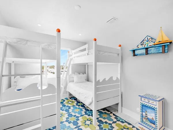 a bedroom with baby crib and hanging chair