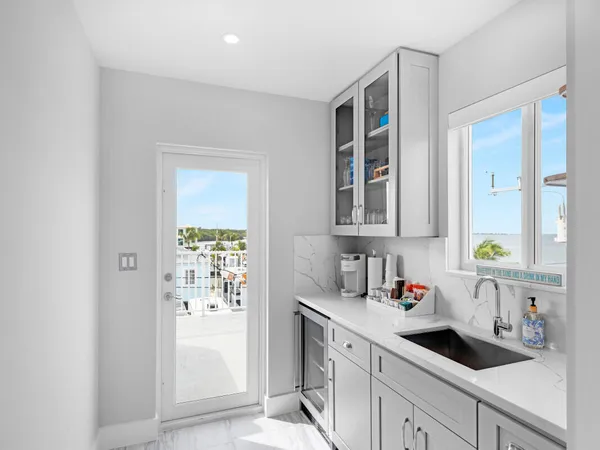 a sink with a window and cabinets