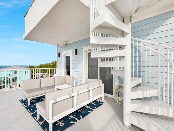 a view of a balcony with two chairs