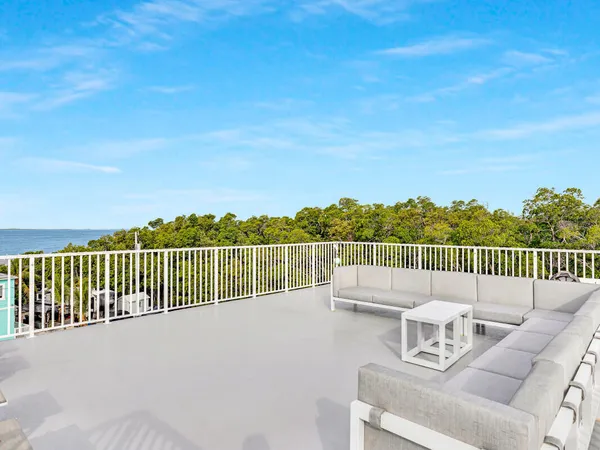 a balcony with a table and chairs