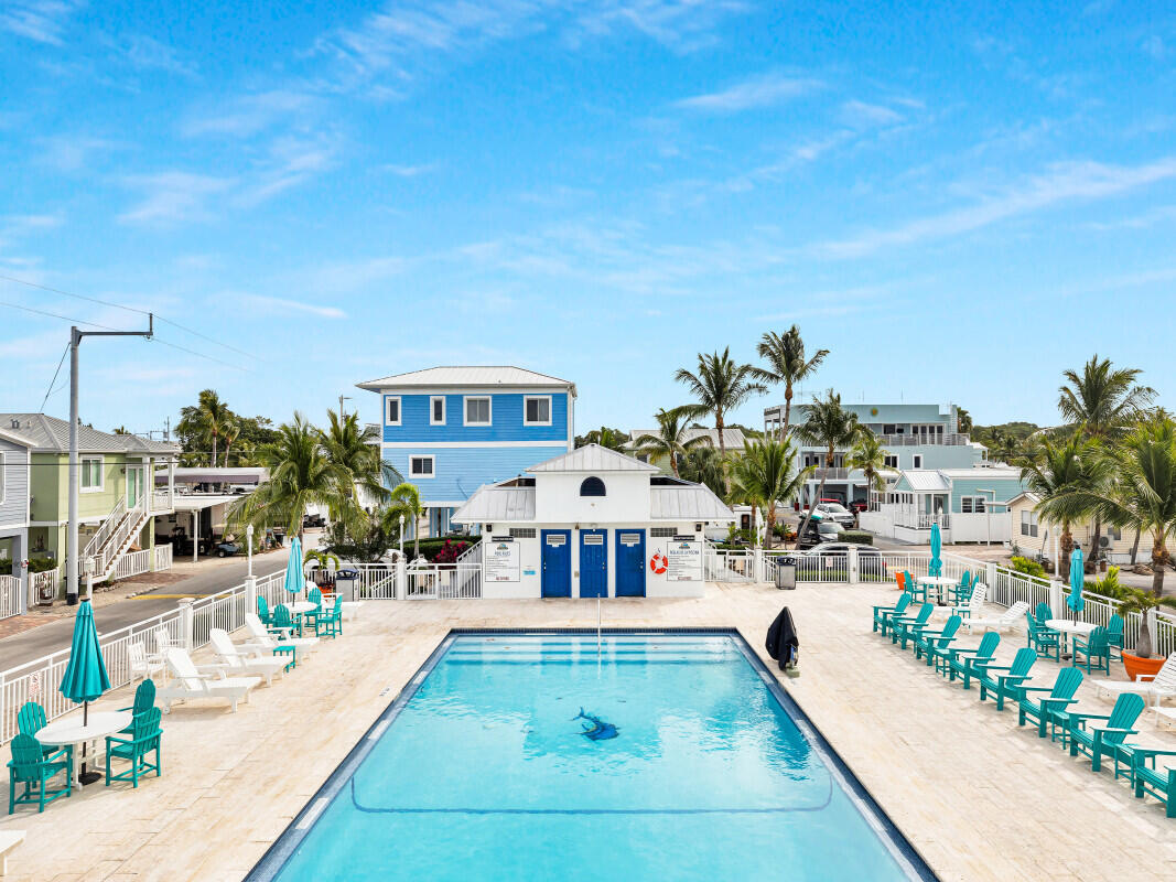 325 Calusa Street, Unit 359 Key Largo, FL 33037 - Photo 40 of 52 a view of a swimming pool with outdoor seating