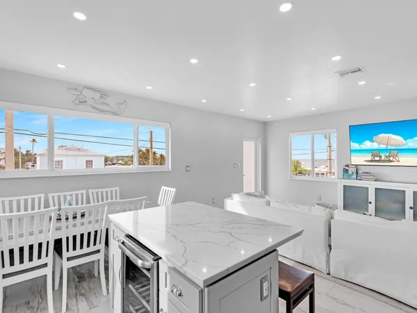 a view of a dining room with furniture and a kitchen