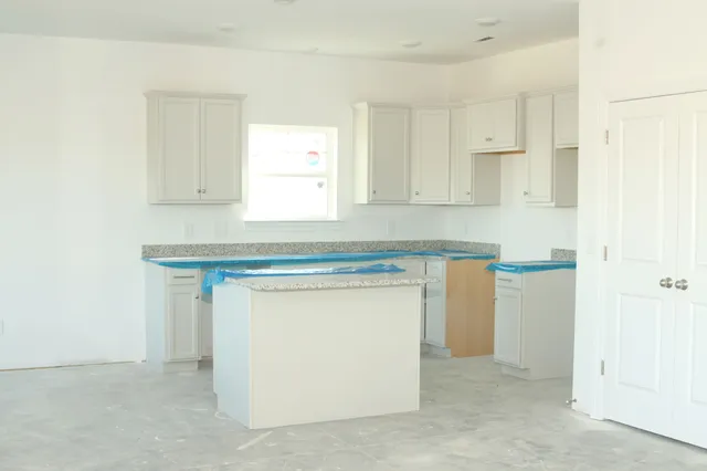 a bathroom with a granite countertop sink and vanity