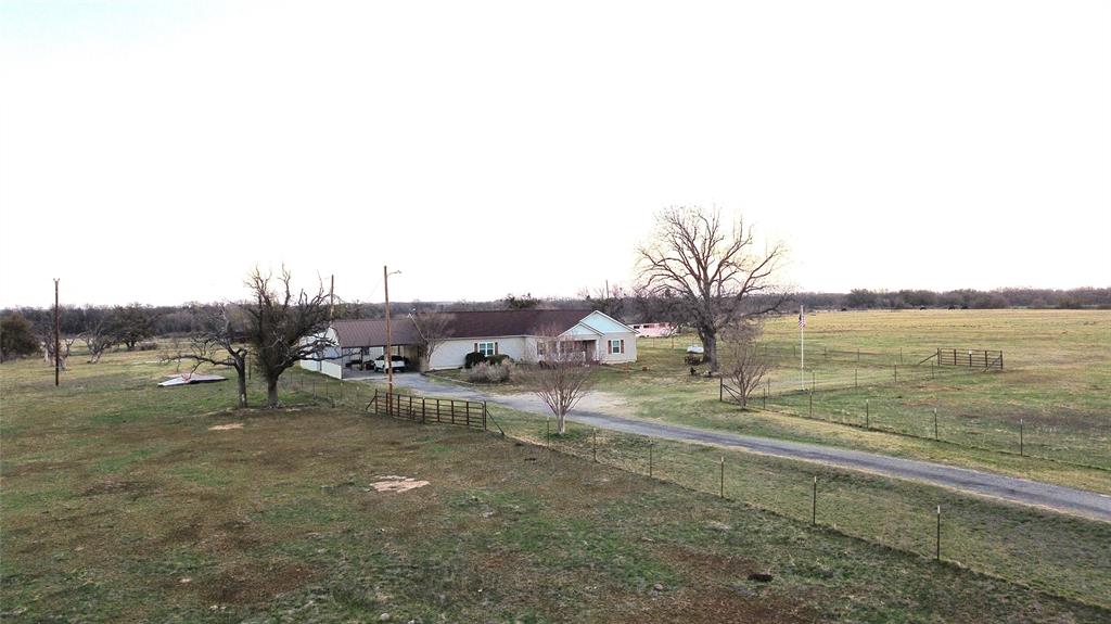 12301 Highway 36 Comanche, TX 76442 - Photo 2 of 28 View of yard featuring a rural view, driveway, and fence