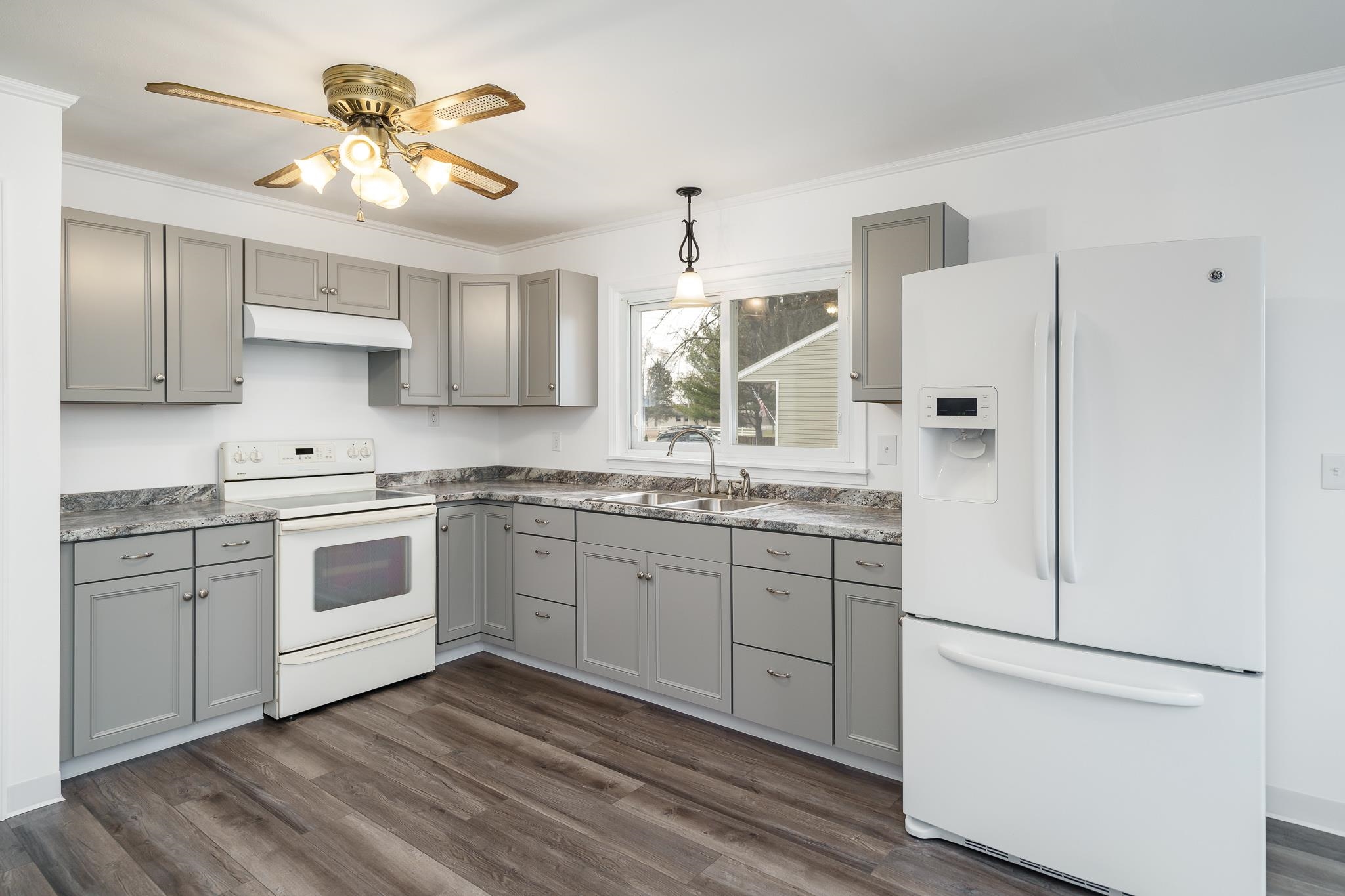 5889 Whiting Road Poplar Grove, IL 61065 - Photo 20 of 40 a kitchen with a stove a sink and a refrigerator