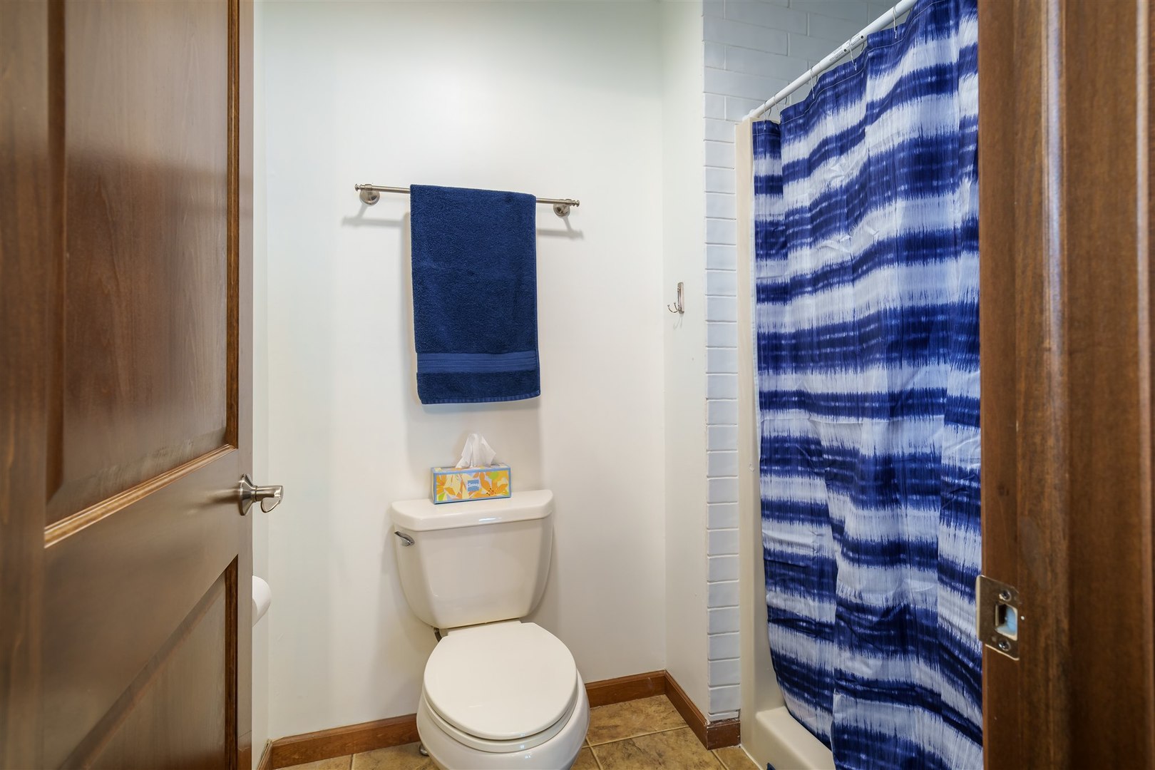 704 Franklin Way Pontiac, IL 61764 - Photo 16 of 39 a white toilet sitting next to a shower curtain