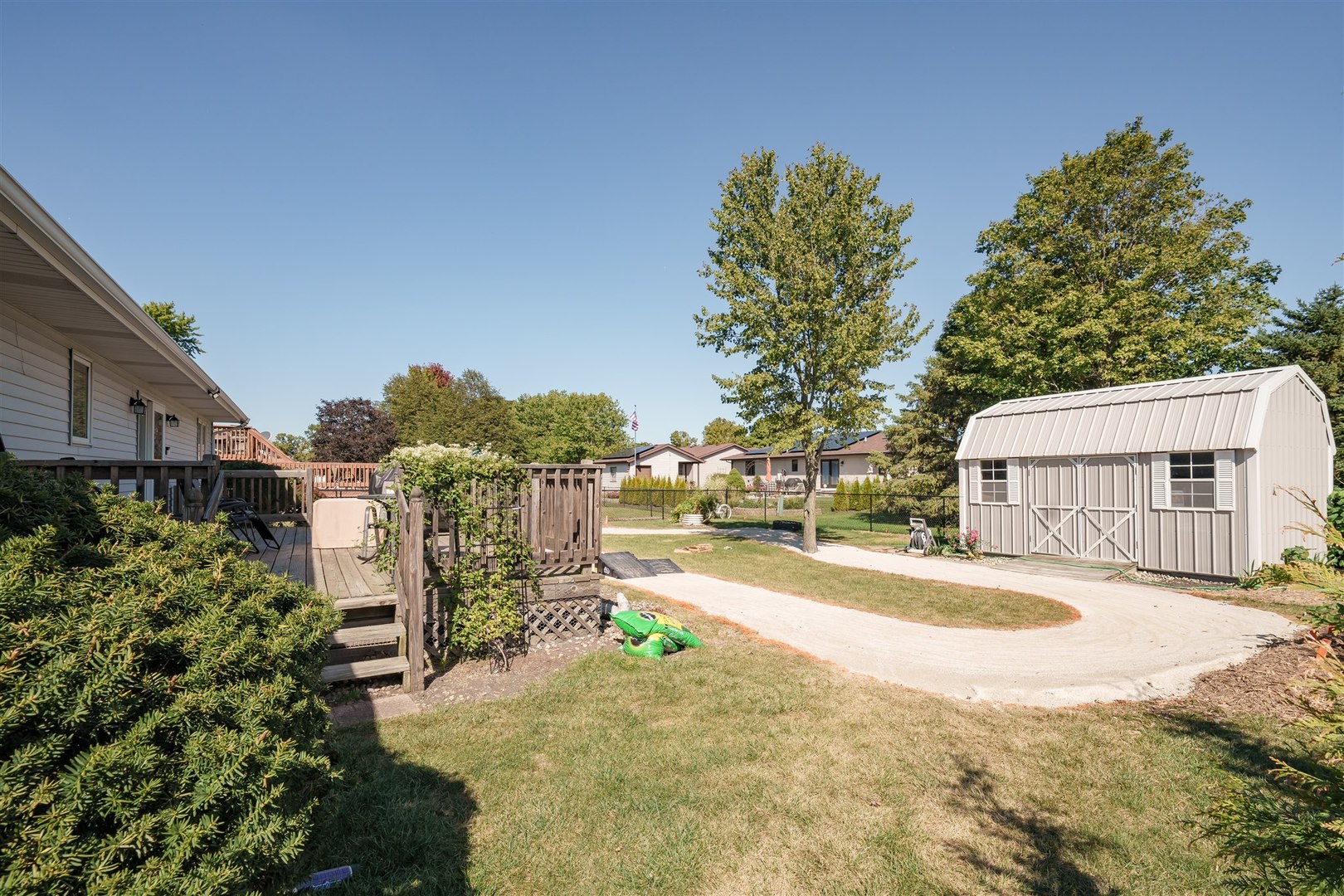 704 Franklin Way Pontiac, IL 61764 - Photo 30 of 39 a view of a house with large trees and a small yard