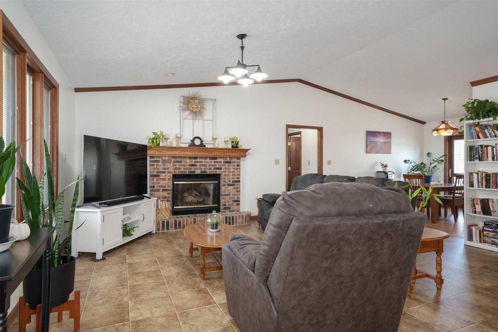 704 Franklin Way Pontiac, IL 61764 - Photo 3 of 39 a living room with furniture a flat screen tv and a fireplace