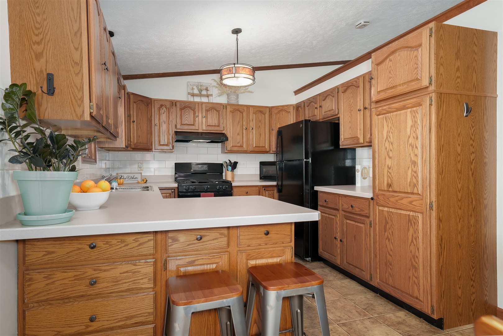 704 Franklin Way Pontiac, IL 61764 - Photo 8 of 39 a kitchen with stainless steel appliances granite countertop a refrigerator a sink dishwasher a stove a dining table and chairs with wooden floor