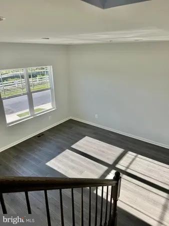 a view of a room with wooden floor