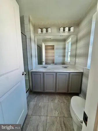 a bathroom with a sink a toilet and mirror